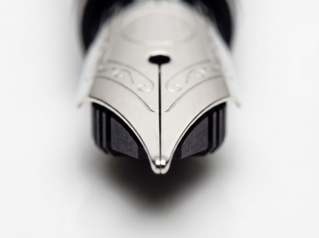 close-up of a fountain pen nib showing the central slit and aligned tines for troubleshooting inspection