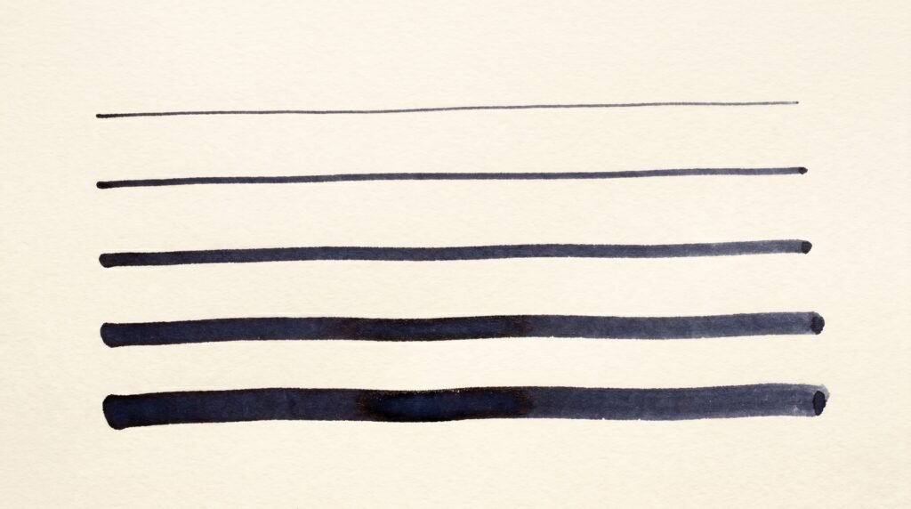 Five fountain pen nib size line samples from extra fine to double broad on cream paper