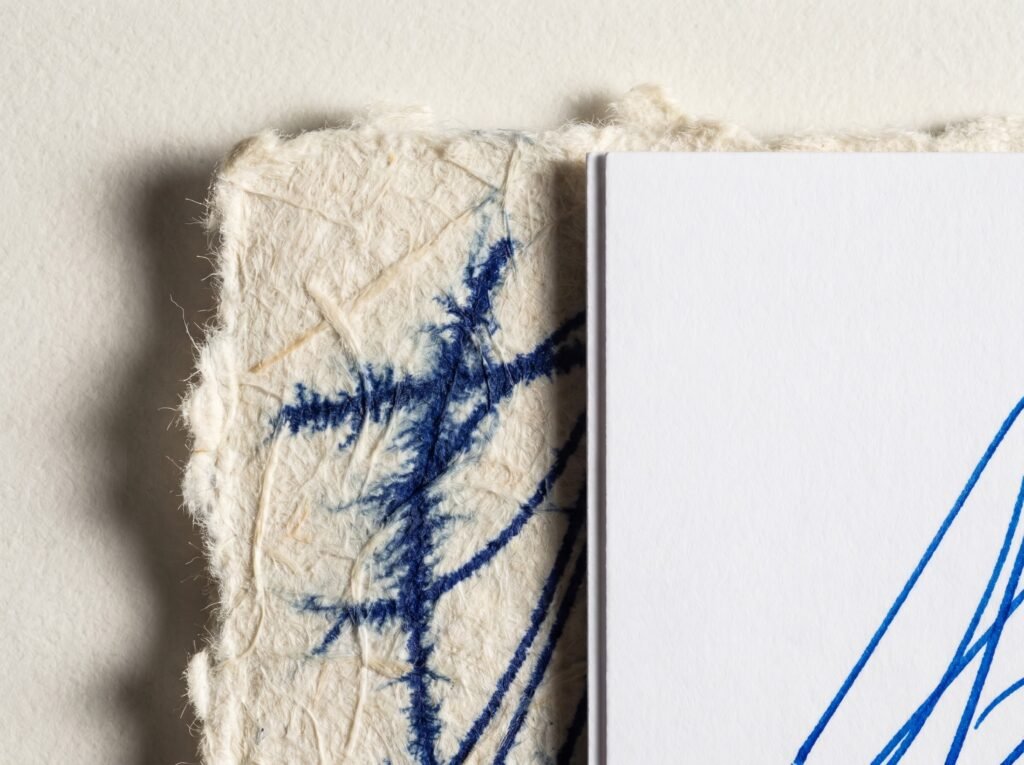Macro view comparing unsized fibrous paper with feathering versus smooth coated paper with sharp ink lines